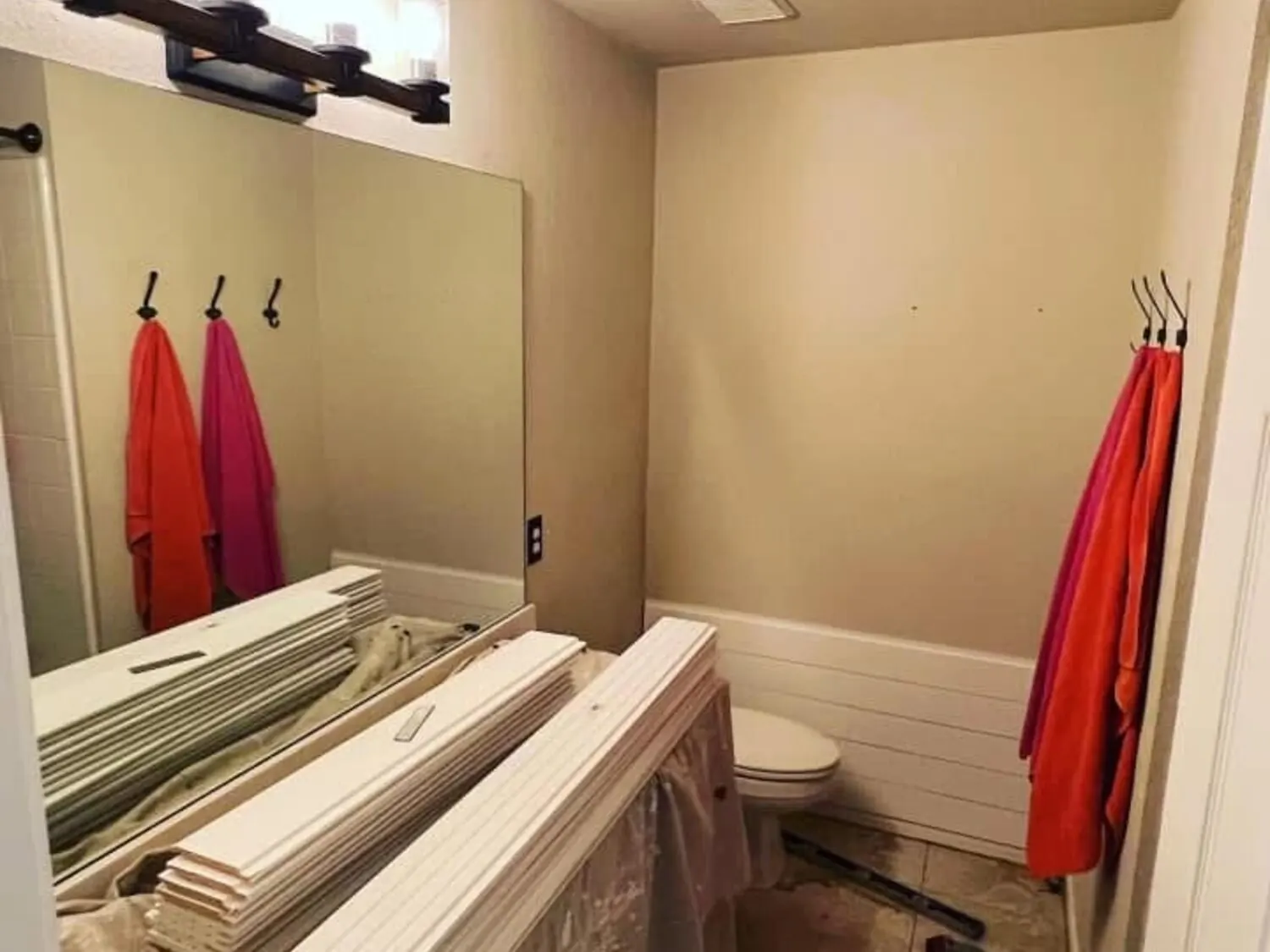 Bathroom before remodel with old vanity wall