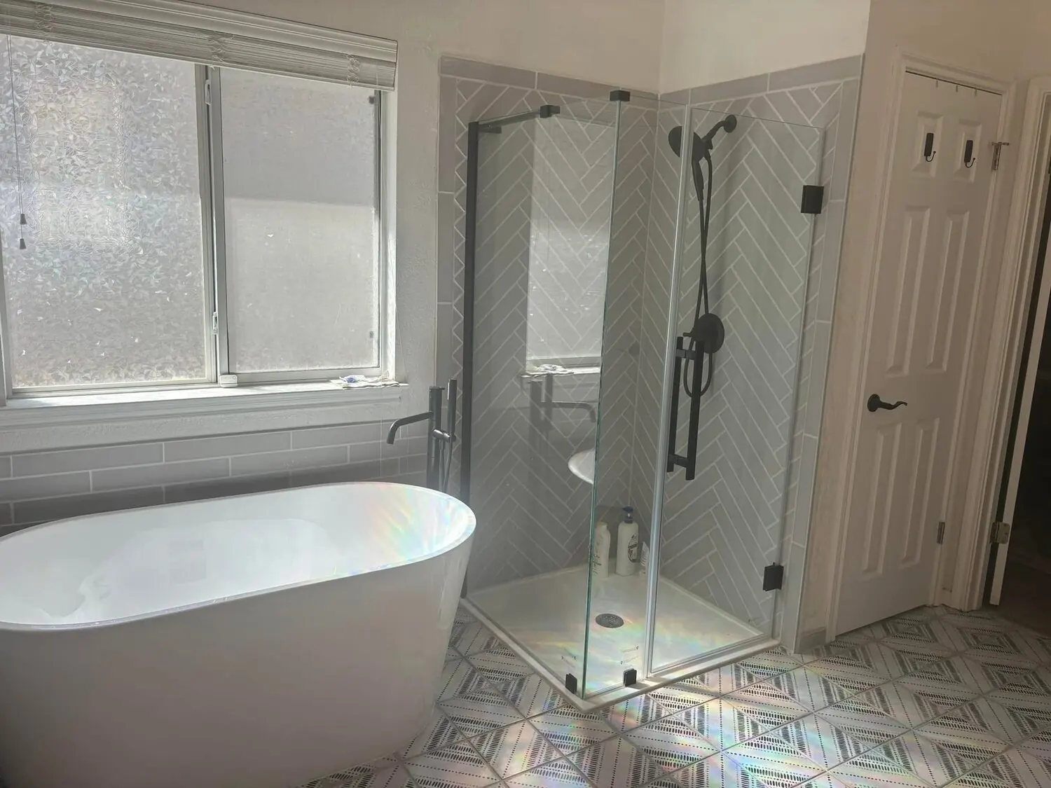 Bathroom after remodel with glass shower and freestanding tub