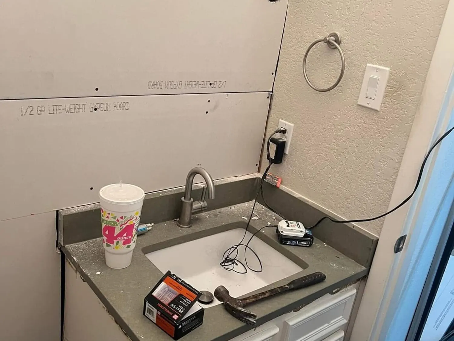 Bathroom before remodel with vanity removed