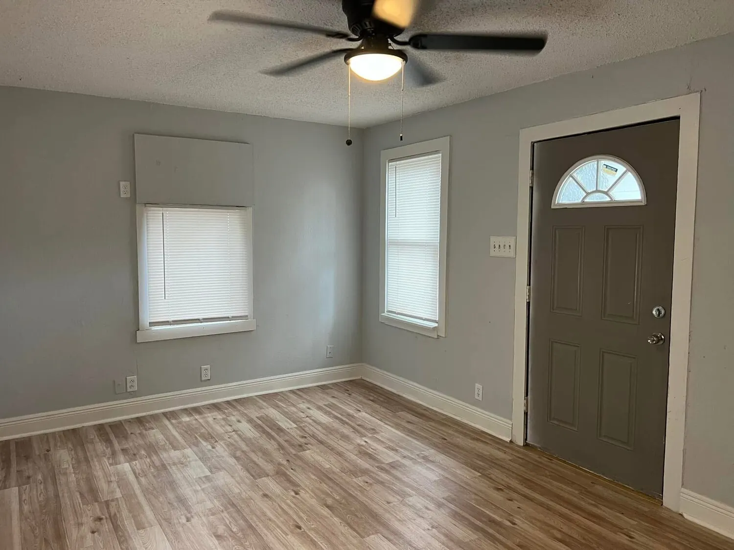 Front room after flooring, trim, paint, and entry finish