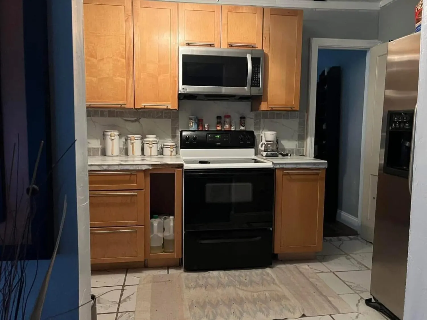 Kitchen area after remodel with cabinets, appliances, and finished floor