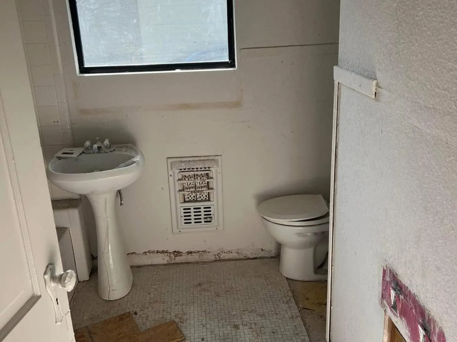Bathroom before remodel with fixtures removed
