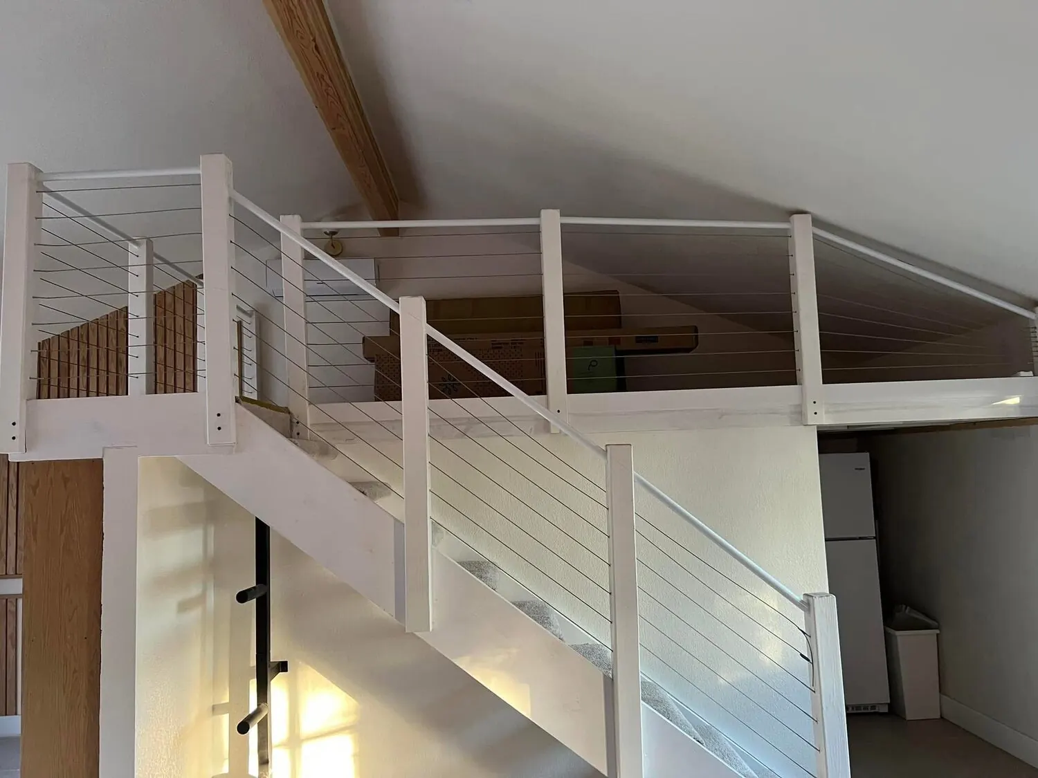 Garage conversion after with stairs, railings, and finished loft